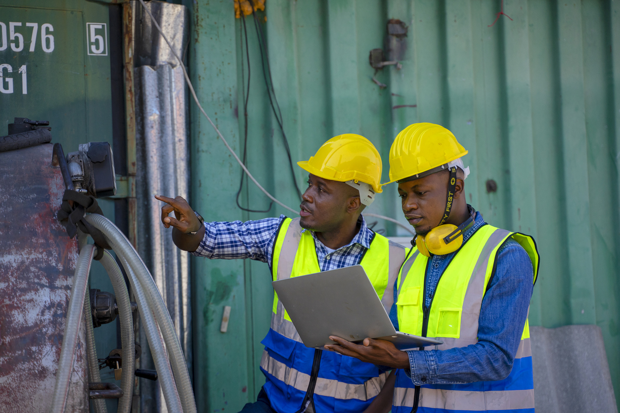 Two hard hat workers consulting on electric issue
