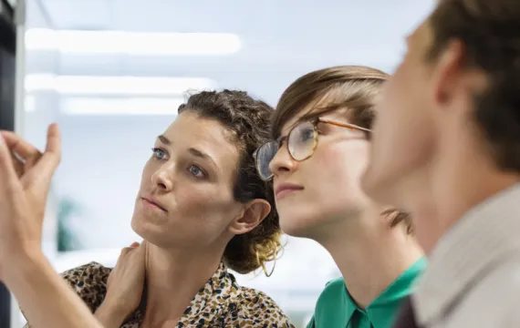 Team looking at work whiteboard