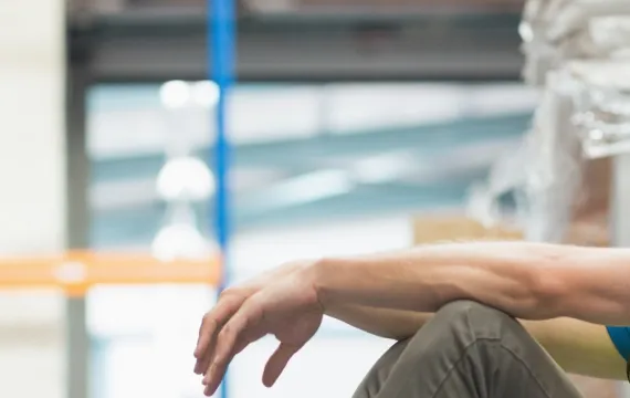 Exhausted worker sitting down on job
