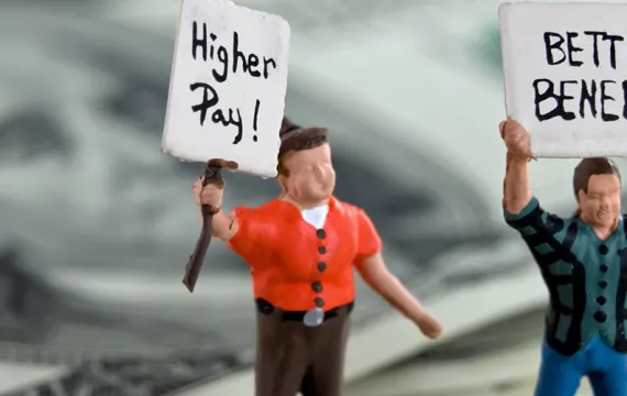Clay characters holding signs