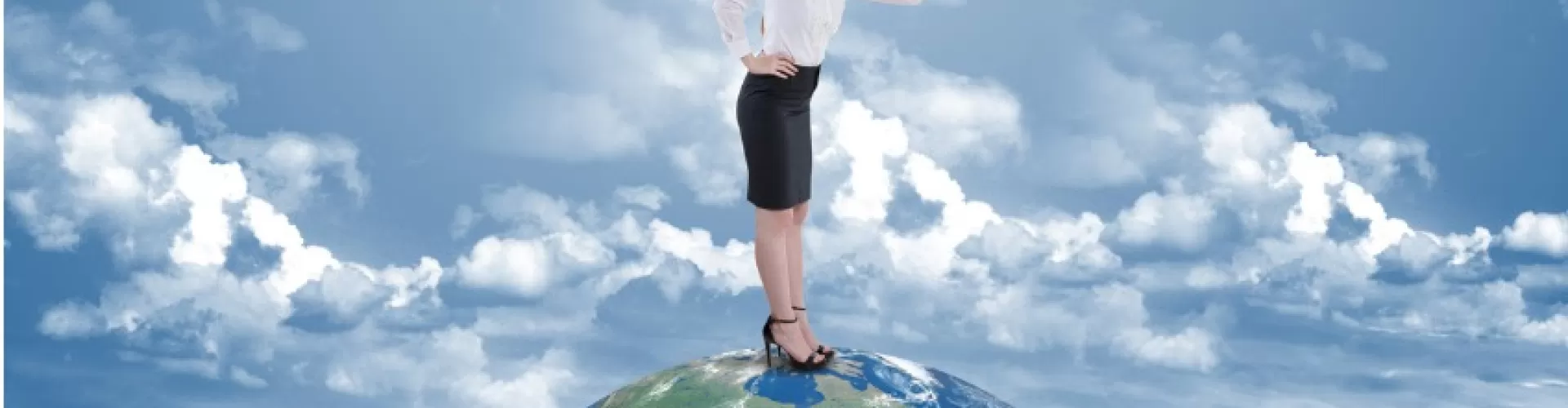 Businesswoman searching through telescope on top of the world