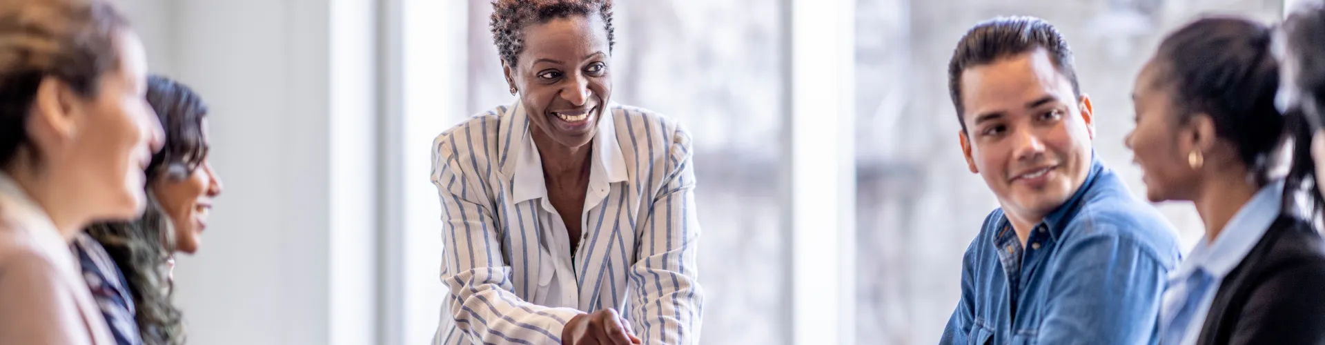 Leader at a conference table with employees