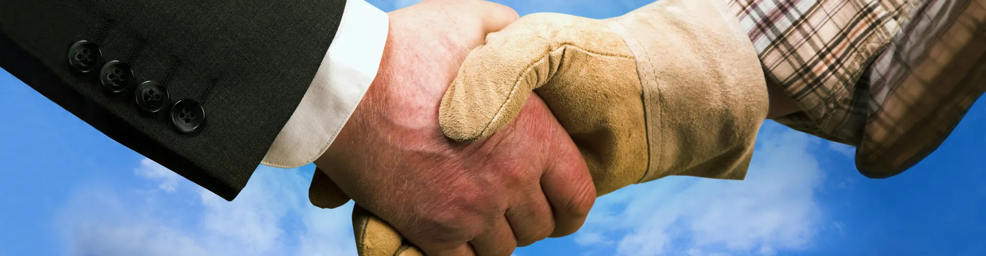 Executive and frontline worker shaking hands