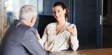 Young manager speaking with an older employee