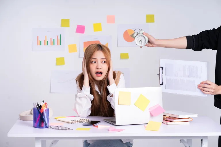 Young worker being pressured by a manager holding a clock